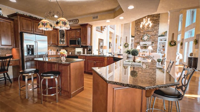 1564 Tranquility Trl, Dandridge, TN 37725 - kitchen with stainless steel appliances, a peninsula, wood finished floors, a kitchen breakfast bar, and recessed lighting