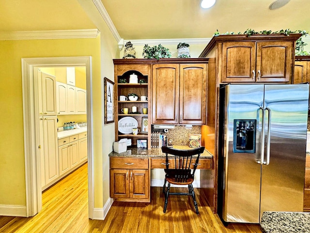 1564 Tranquility Trl, Dandridge, TN 37725 - kitchen with stainless steel refrigerator with ice dispenser, wood finished floors, crown molding, baseboards, and dark stone counters