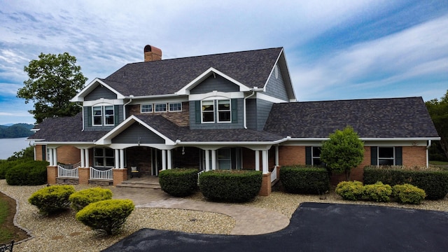 1564 Tranquility Trl, Dandridge, TN 37725 - craftsman inspired home with covered porch, a chimney, and brick siding