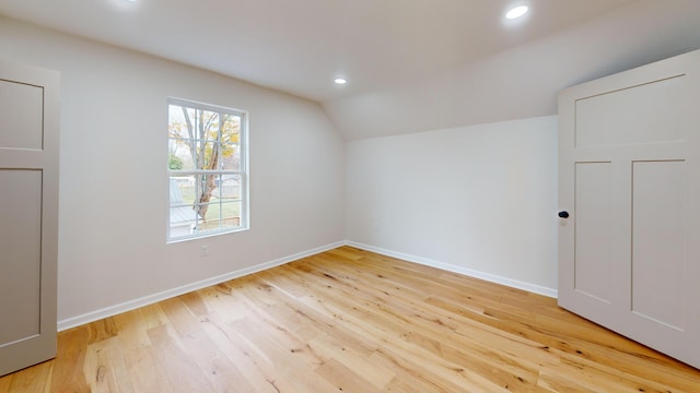 bonus room featuring lofted ceiling and light hardwood / wood-style flooring