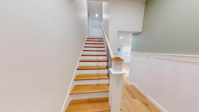 staircase with hardwood / wood-style floors