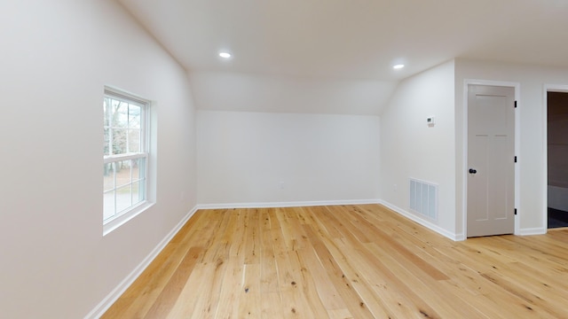 bonus room with hardwood / wood-style flooring and lofted ceiling