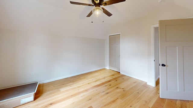 unfurnished bedroom featuring a closet, light hardwood / wood-style flooring, and ceiling fan