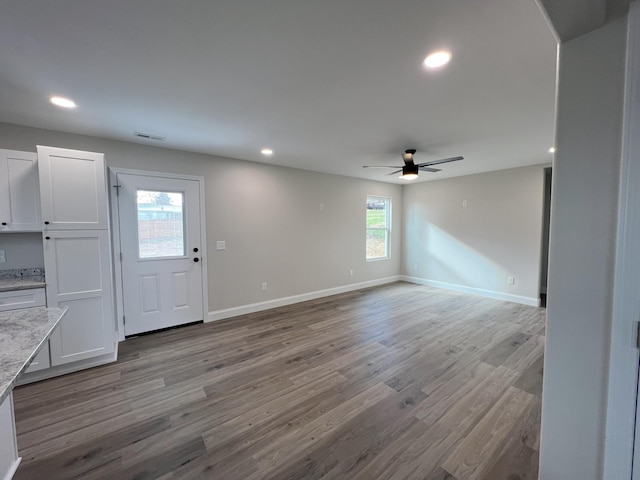 unfurnished living room featuring ceiling fan and light hardwood / wood-style floors