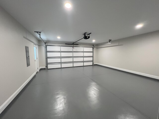 garage featuring electric panel and a garage door opener