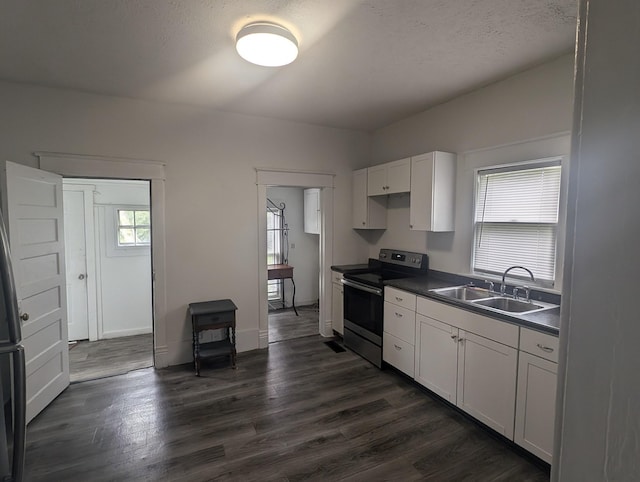 kitchen featuring stainless steel range with electric stovetop, white cabinets, sink, and dark wood-type flooring