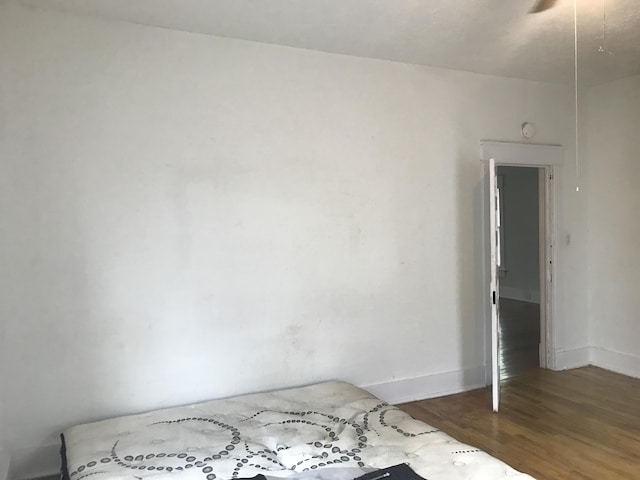 unfurnished room with dark wood-type flooring