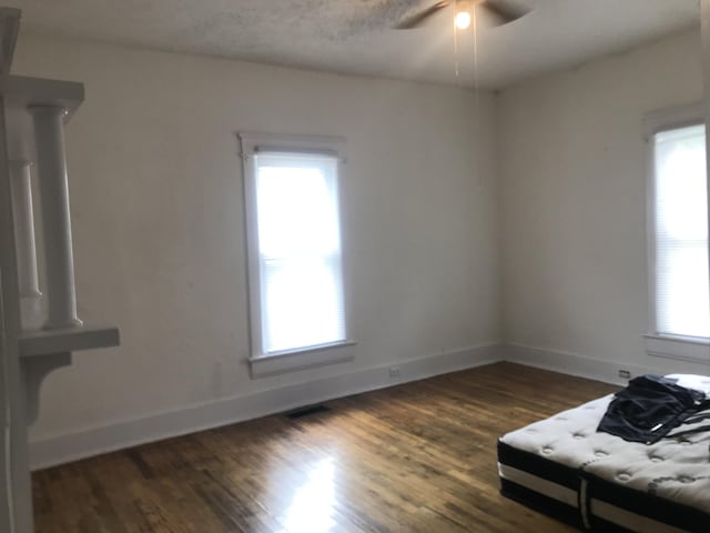 interior space featuring ceiling fan and dark hardwood / wood-style flooring