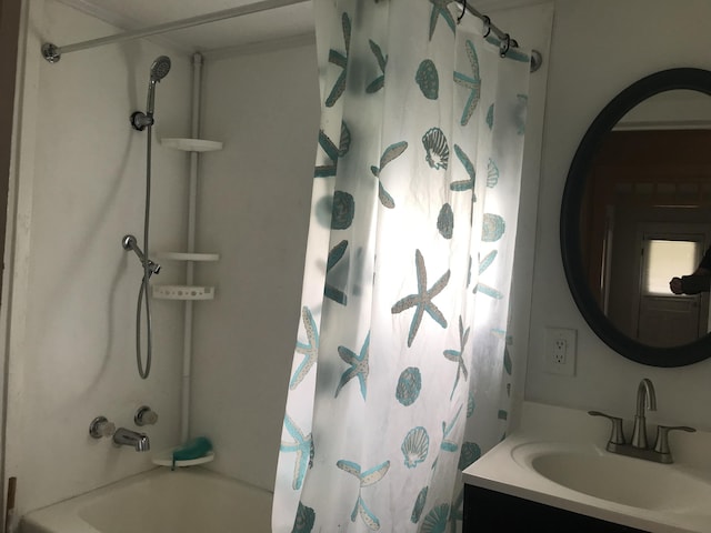 bathroom featuring vanity and shower / bath combo with shower curtain