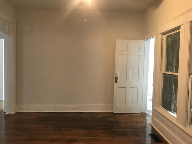 spare room featuring dark hardwood / wood-style flooring