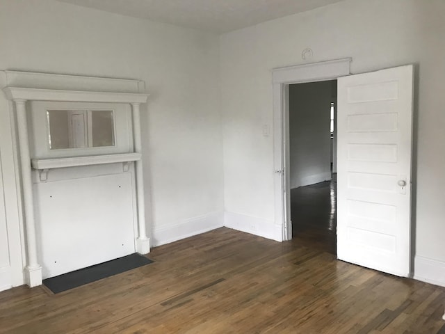 empty room with dark hardwood / wood-style floors