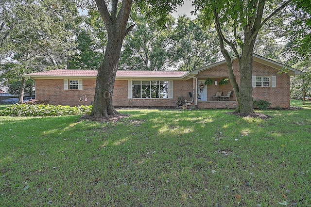 ranch-style home with a front yard and brick siding