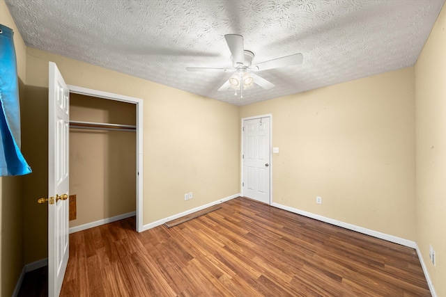 bedroom featuring ceiling fan, wood-type flooring, a closet, and a textured ceiling