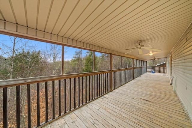 wooden deck featuring ceiling fan