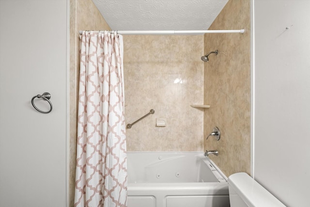 bathroom with shower / bath combo with shower curtain and a textured ceiling