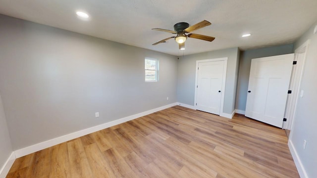 unfurnished bedroom featuring a ceiling fan, recessed lighting, light wood-style flooring, and baseboards