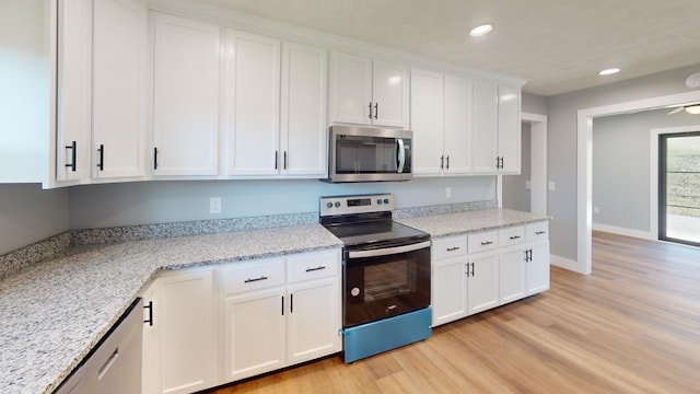 kitchen with light wood-style floors, white cabinetry, appliances with stainless steel finishes, and recessed lighting