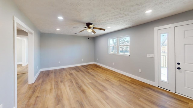 foyer entrance featuring baseboards, ceiling fan, a textured ceiling, light wood-style floors, and recessed lighting