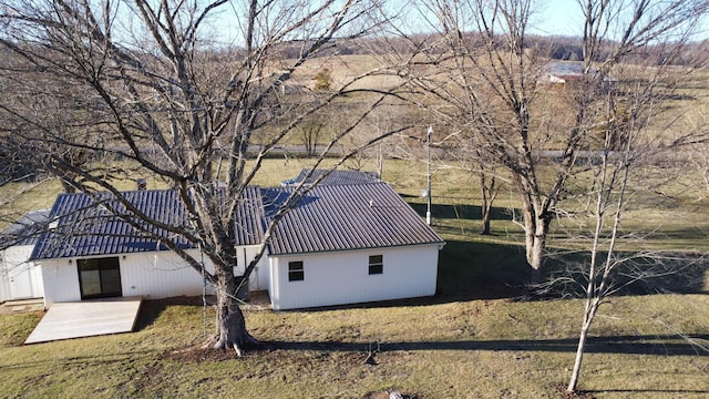 view of side of home with metal roof