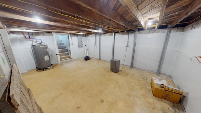 unfinished below grade area featuring water heater and electric panel