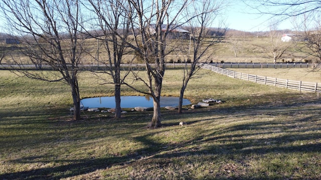 view of yard with a rural view and fence