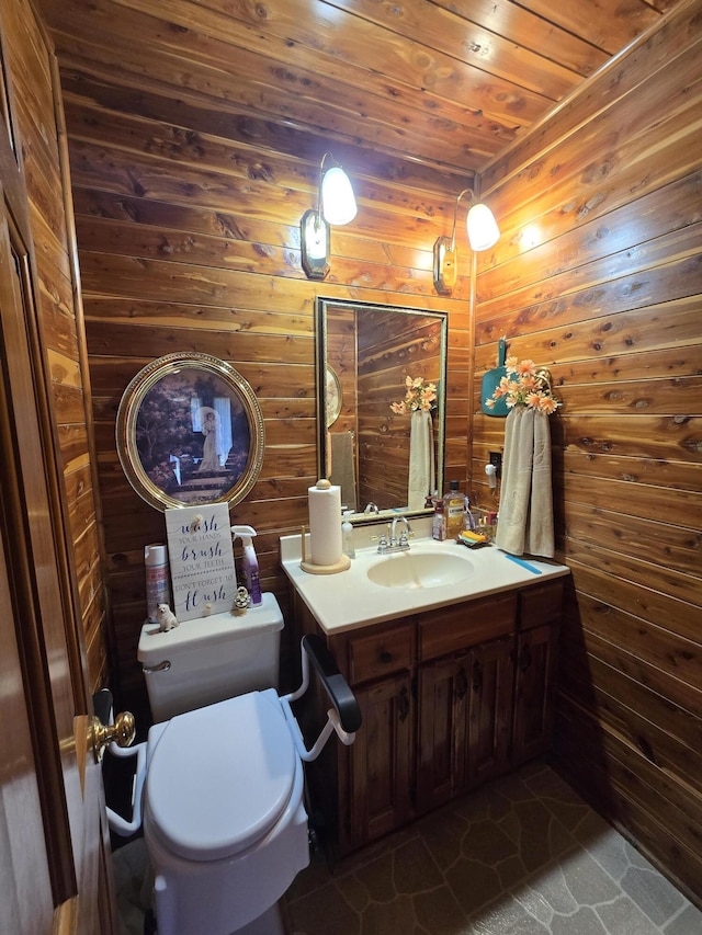 bathroom featuring wooden ceiling, toilet, vanity, wood walls, and tile patterned flooring