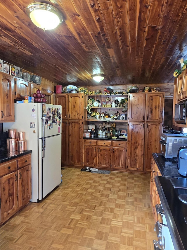 kitchen with freestanding refrigerator, black microwave, brown cabinetry, open shelves, and wooden ceiling