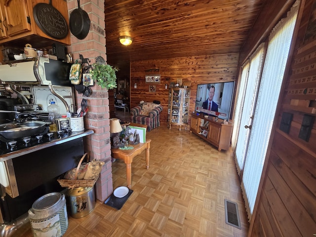 living room with wooden walls and visible vents