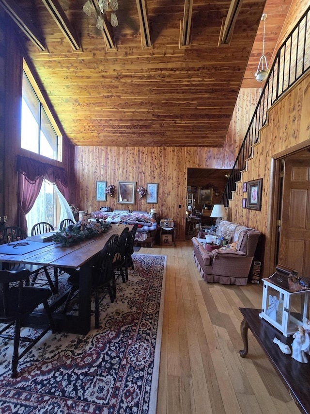 dining area with high vaulted ceiling, stairway, hardwood / wood-style flooring, and wood ceiling