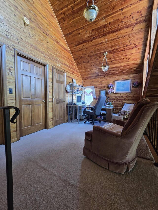 carpeted living area with high vaulted ceiling, wood walls, and wooden ceiling