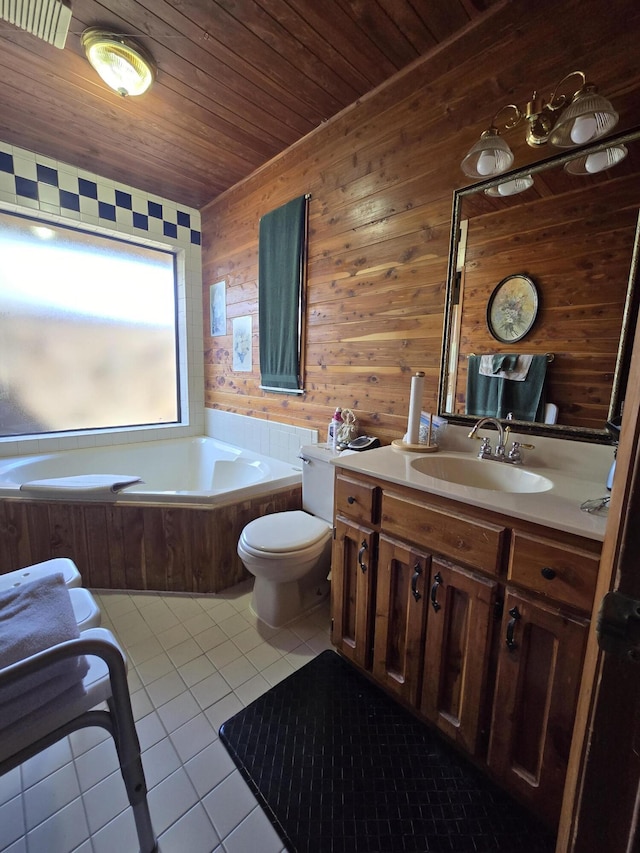 bathroom with a bath, vanity, toilet, wooden ceiling, and tile patterned floors