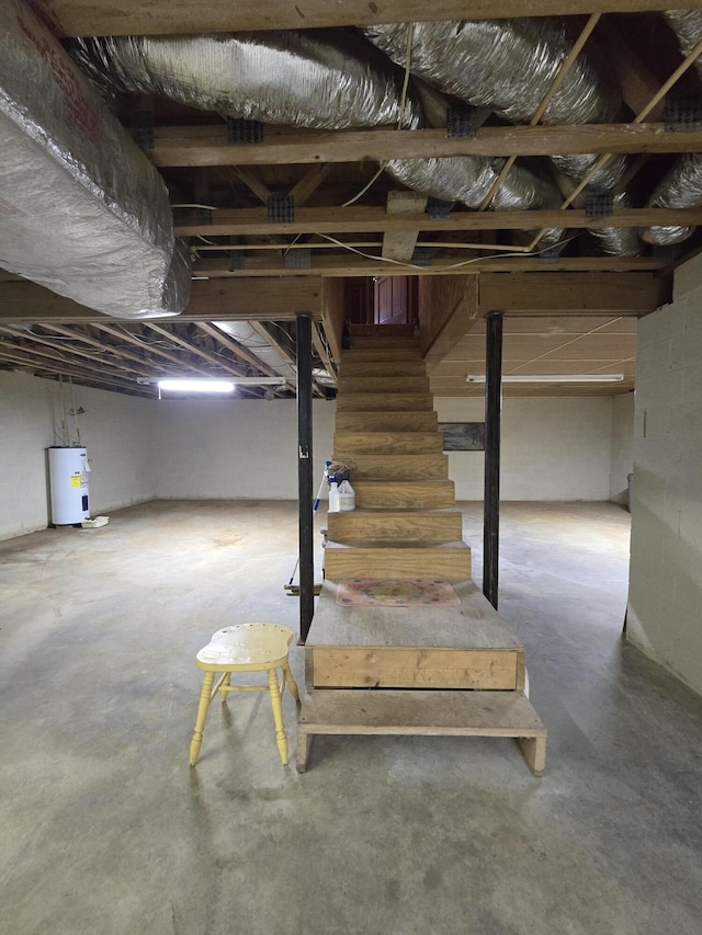 unfinished basement with stairway and water heater