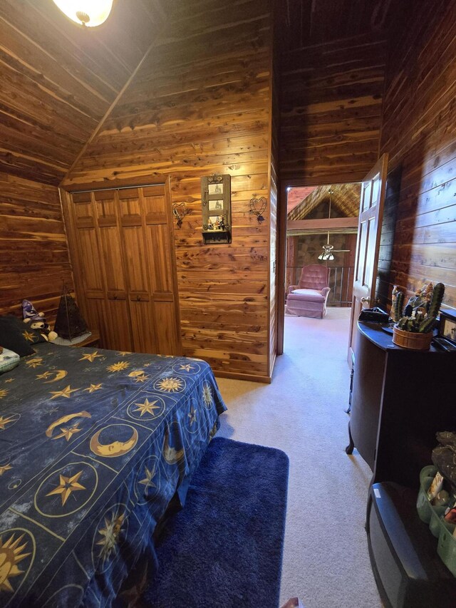 bedroom featuring wood walls, carpet, and vaulted ceiling