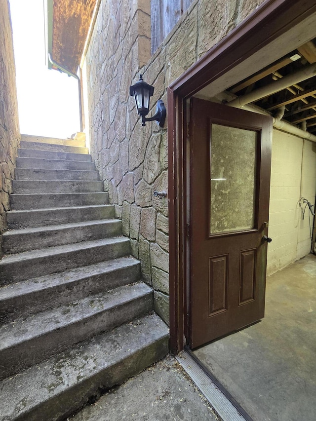 property entrance with stone siding