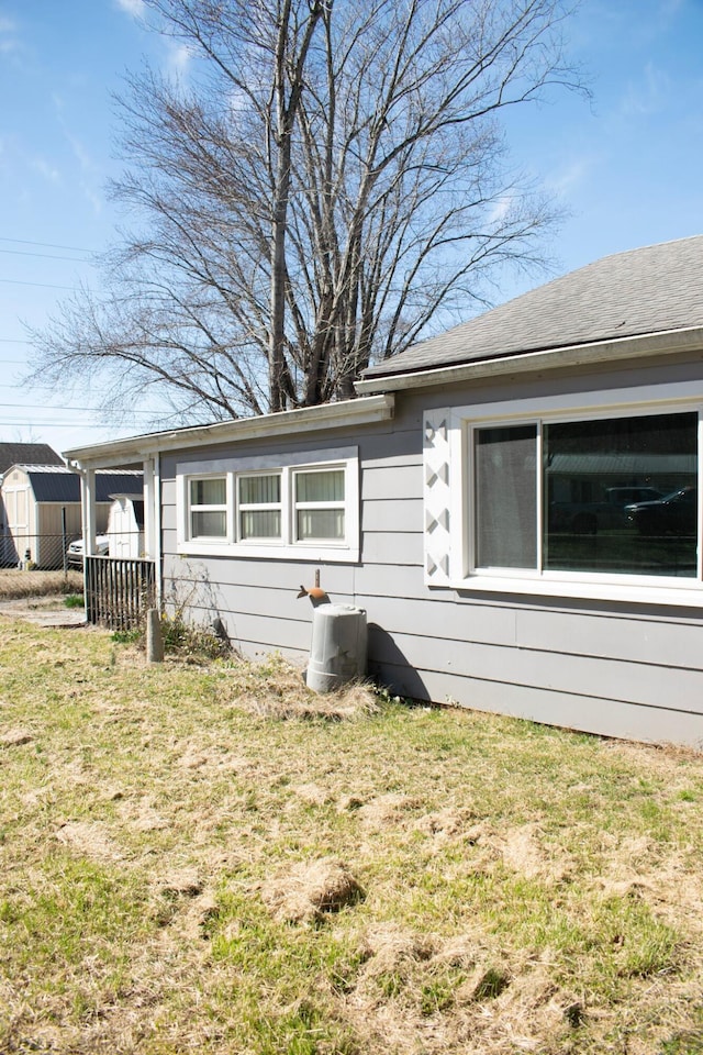 view of side of property with a yard and fence