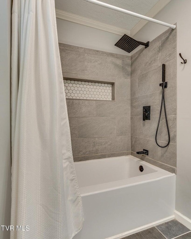 full bath with tile patterned floors, a textured ceiling, and shower / bath combo