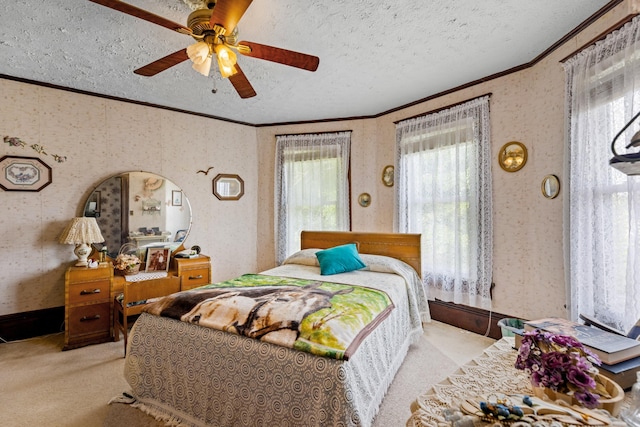 carpeted bedroom featuring ceiling fan and a textured ceiling