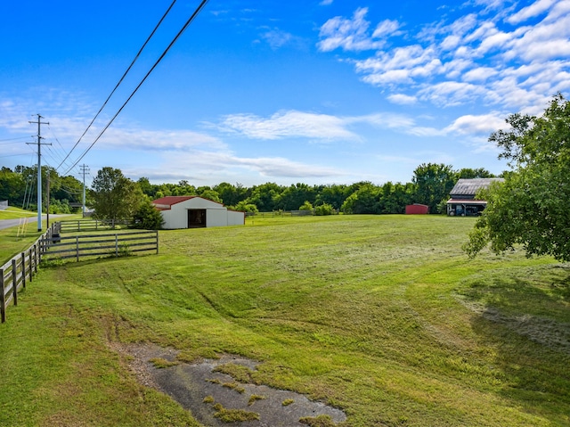 view of yard featuring a rural view and an outdoor structure