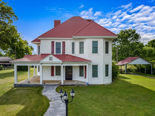 view of front of home with a porch, a carport, and a front lawn