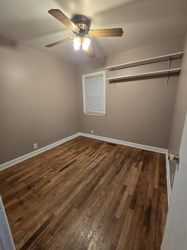 spare room with ceiling fan and dark wood-type flooring