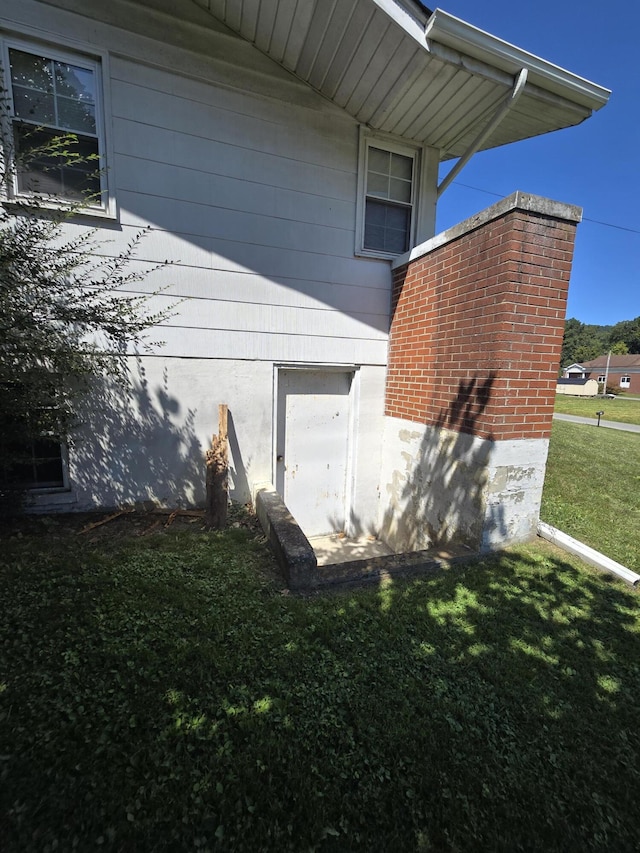 view of home's exterior with a yard