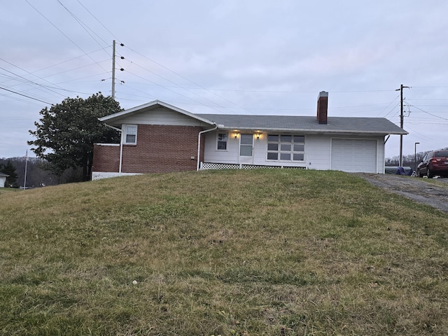 ranch-style home with a front yard and a garage