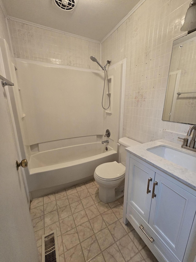 full bathroom with vanity, washtub / shower combination, crown molding, toilet, and tile walls