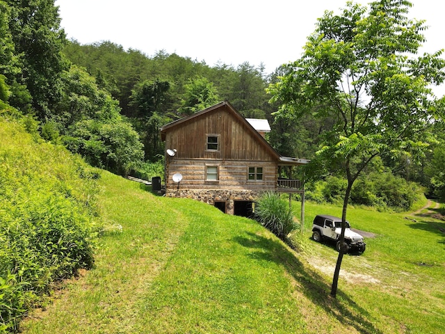 453 Trentham Hollow Rd, Parrottsville, TN 37843 - view of home's exterior with a view of trees, a yard, dirt driveway, log siding, and a wooden deck