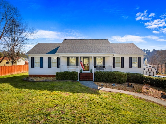 ranch-style home with covered porch and a front yard