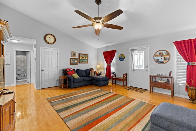 living room with ceiling fan, light hardwood / wood-style flooring, and lofted ceiling