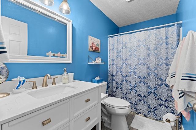 bathroom with toilet, vanity, a textured ceiling, and walk in shower