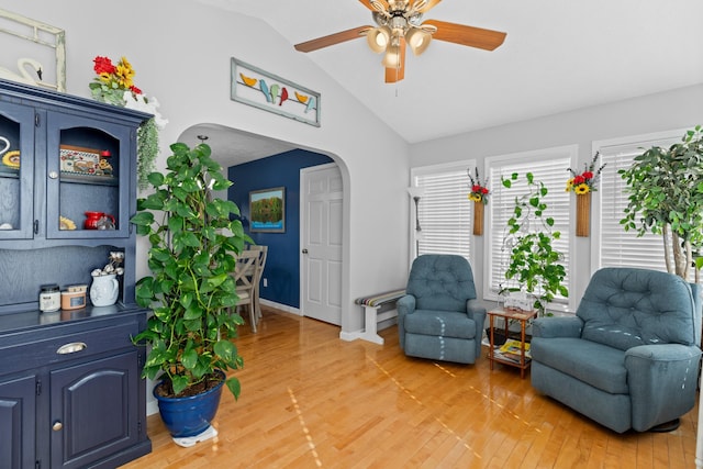 living area featuring ceiling fan, lofted ceiling, and wood-type flooring