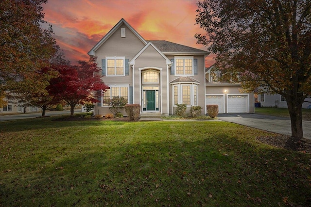 view of front facade with a lawn and a garage