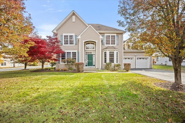 view of front facade with a front yard and a garage